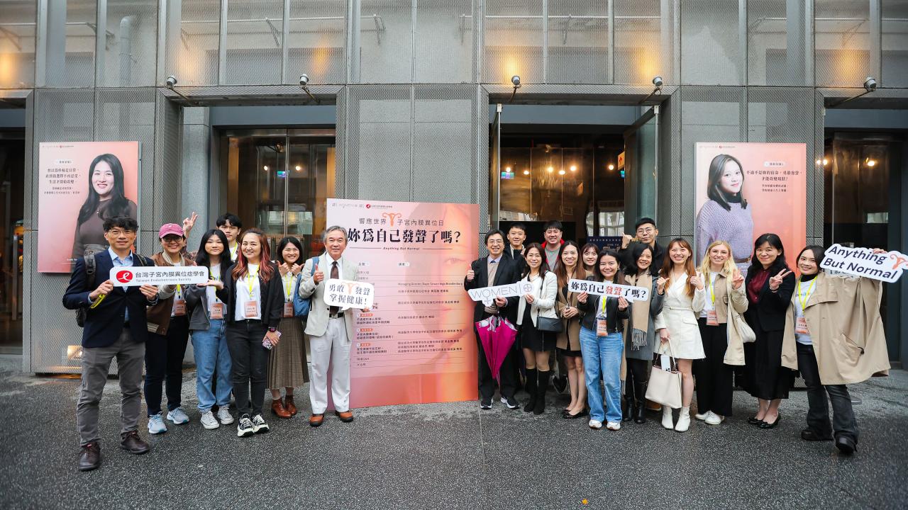 Group photo taken in front of photography exhibition