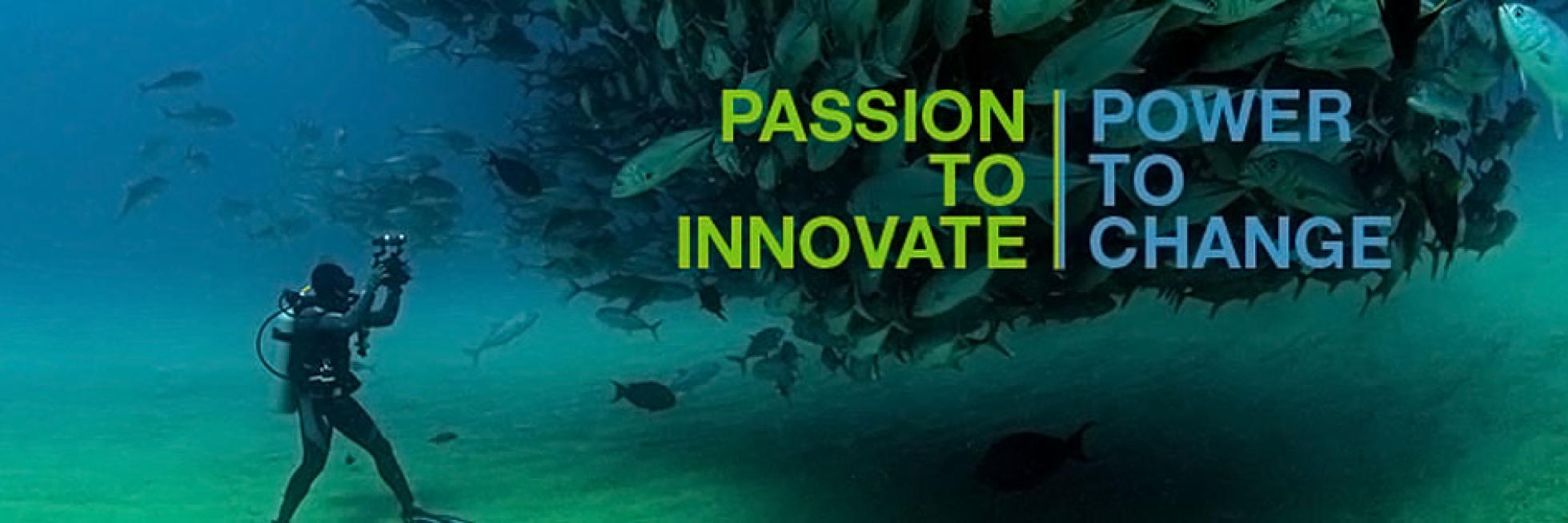 A scuba diver films a large school of fish underwater. The words "Passion to Innovate | Power to Change" are displayed.